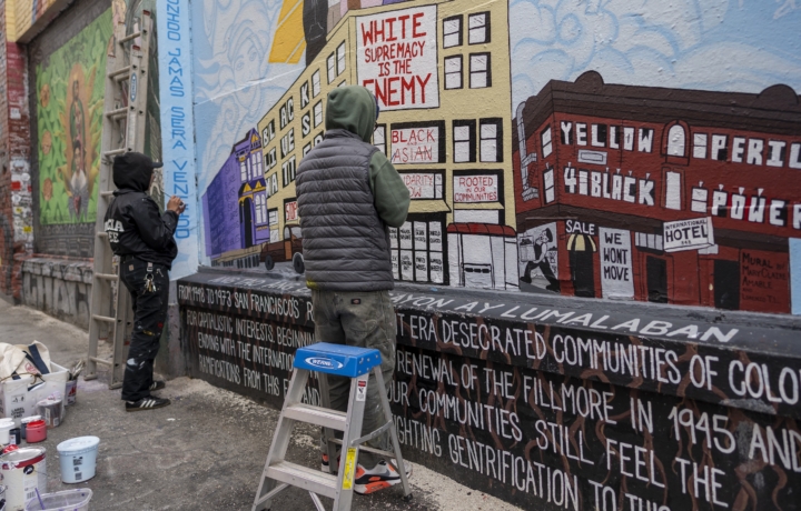 students painting a mural in Clarion Alley in San Francisco