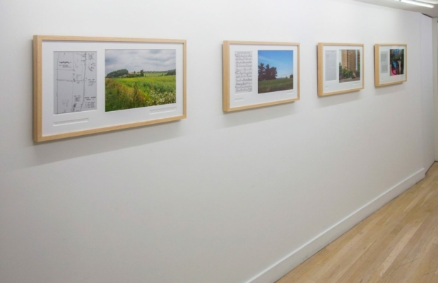4 framed images of landscapes in which prisons are embedded hung on a white wall.