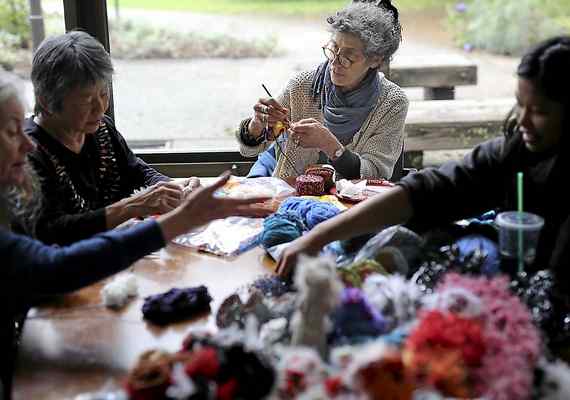People crochet pieces for the UCSC Coral Reef Crochet Exhibit.