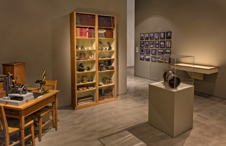 Artifacts and books pictured in an art exhibit.