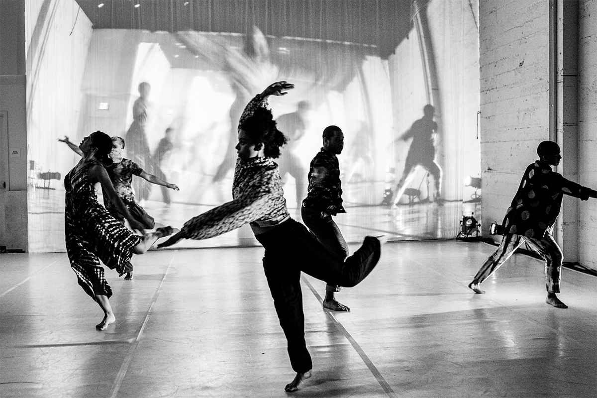 A group of people dance in a studio.