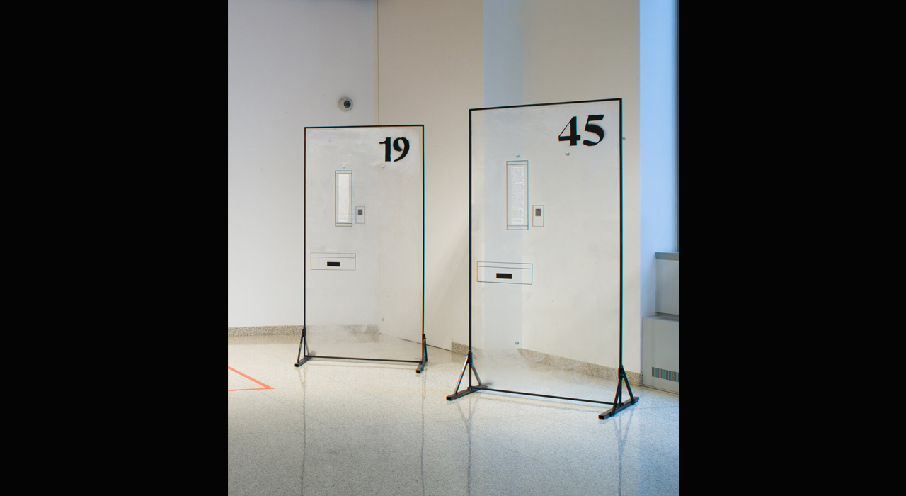 Two objects resembling doors standing up in an art exhibit.