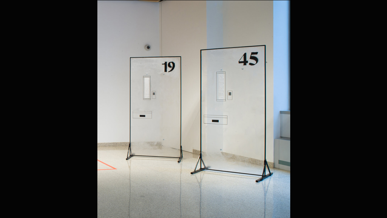 Two objects resembling doors standing up in an art exhibit.