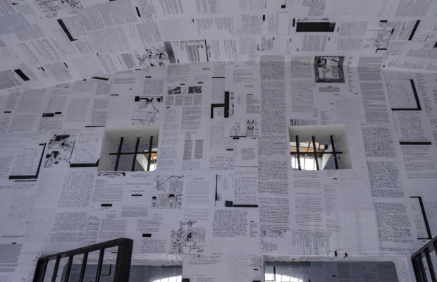 inside of a small jail wheatpasted with letters