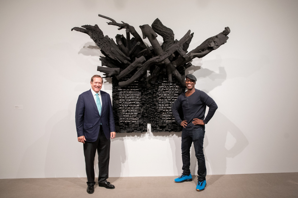 Jordan D. Schnitzer and Leonardo Drew stand in front of an art installation