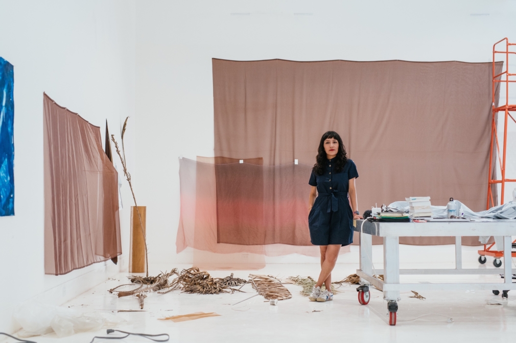 Maria Gaspar standing in their studio