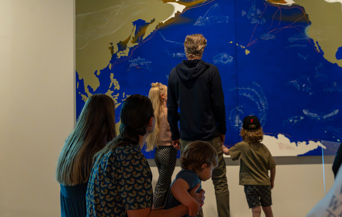 Family looking at Weather and the Whale exhibition