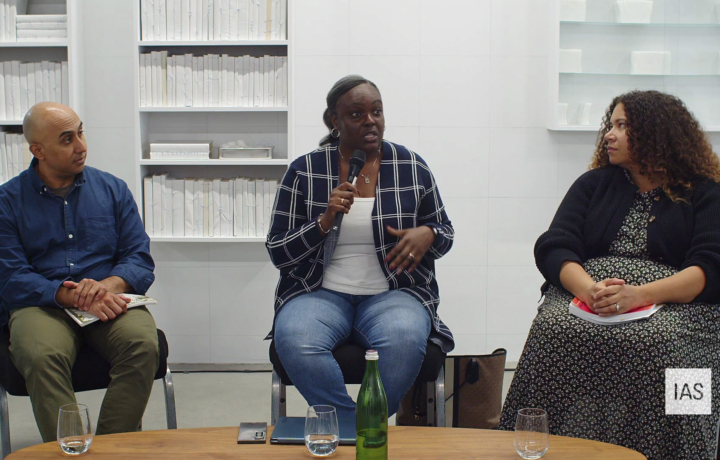 Image of three speakers, seated in a white gallery space.
