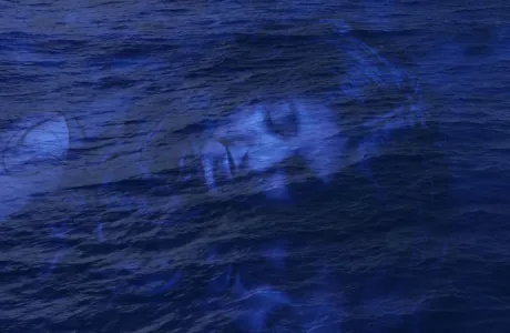 blue tinted image of woman lying down