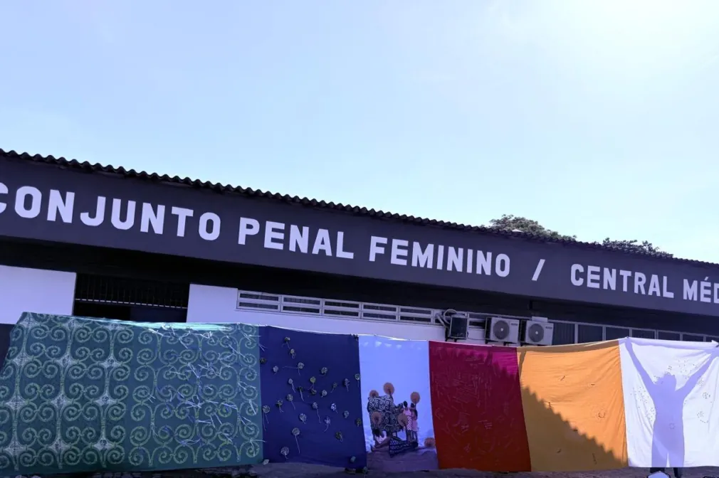 A multi-colored fabric installation held up in front of Conjunto Penal Feminin.